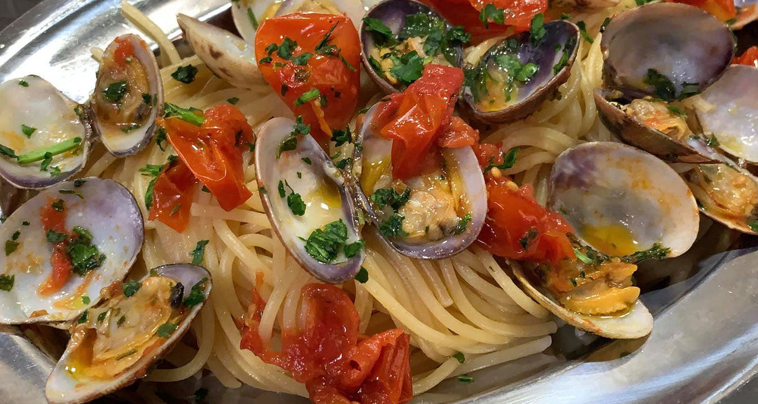 Spaghetti with Clams and chopped Vesuvio Piennolo DOP Cherry Tomatoes