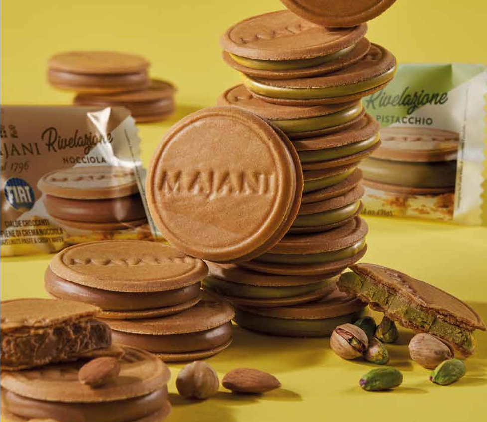 Stack of Majani cookies with packaging on a yellow background